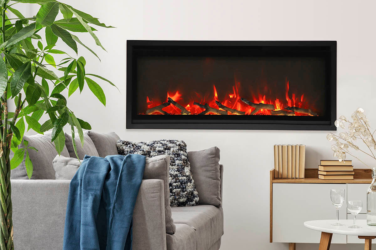 Remii WM-Slim series electric fireplace in a living room with sofa and greenery