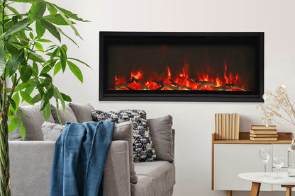Remii WM-Slim series electric fireplace in a living room with sofa and greenery